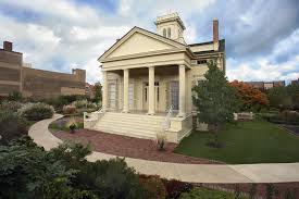 A photo of the exterior of the Clarke House Museum - it is beige and has colums and stairs in the front