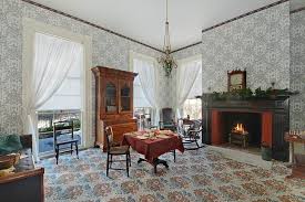 An interior photo of the drawing room in the Clarke House - with fireplace lit.