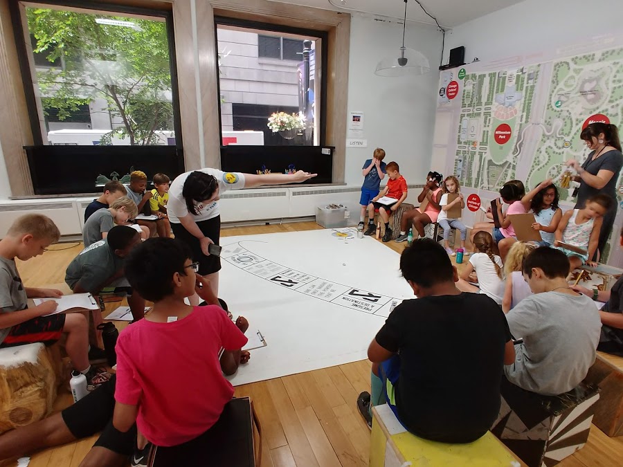 a group of youth and their chaperone explore the activities in the Learning Lab together